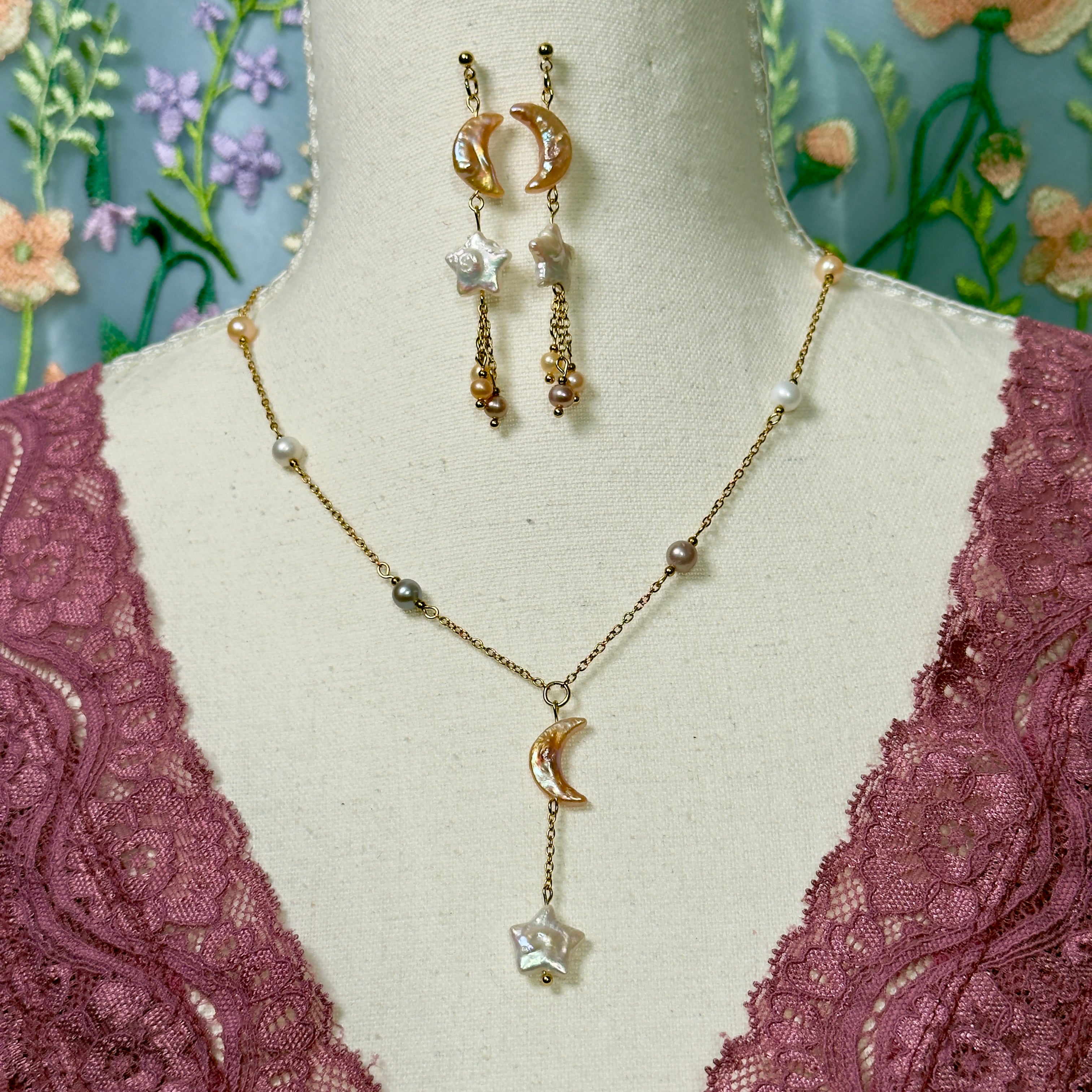 Jewelry set with necklace and earrings on a mannequin bust with floral background