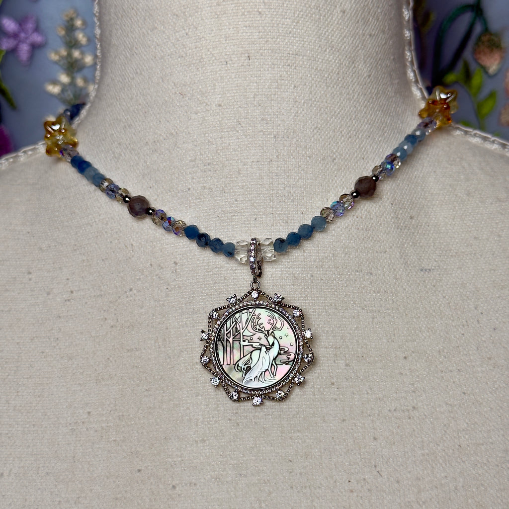 Necklace with a detailed pendant on a mannequin bust