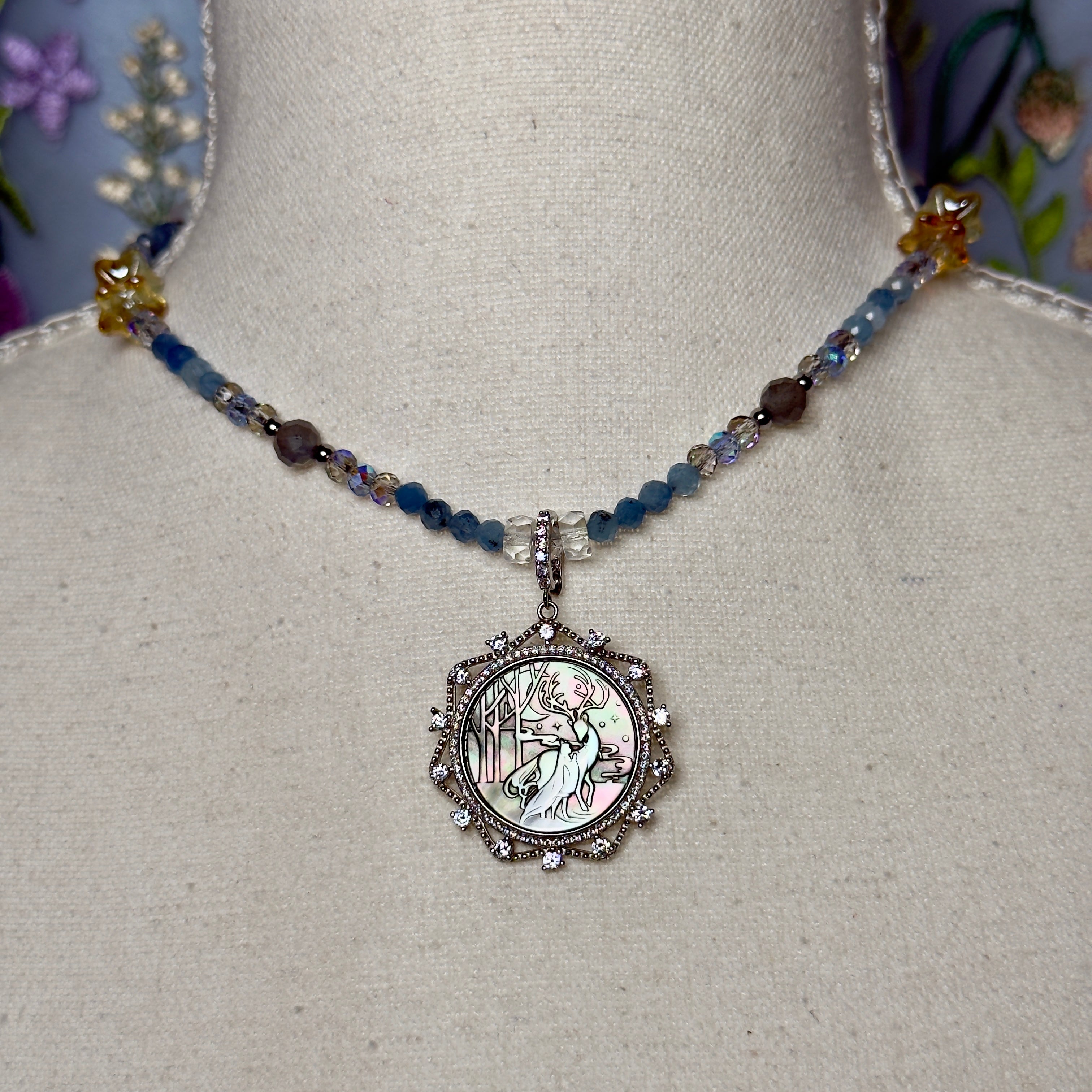 Necklace with a detailed pendant on a mannequin bust