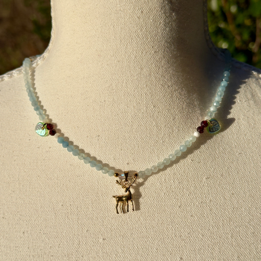 Necklace with a deer charm on a mannequin bust