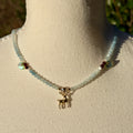 Necklace with a deer charm on a mannequin bust