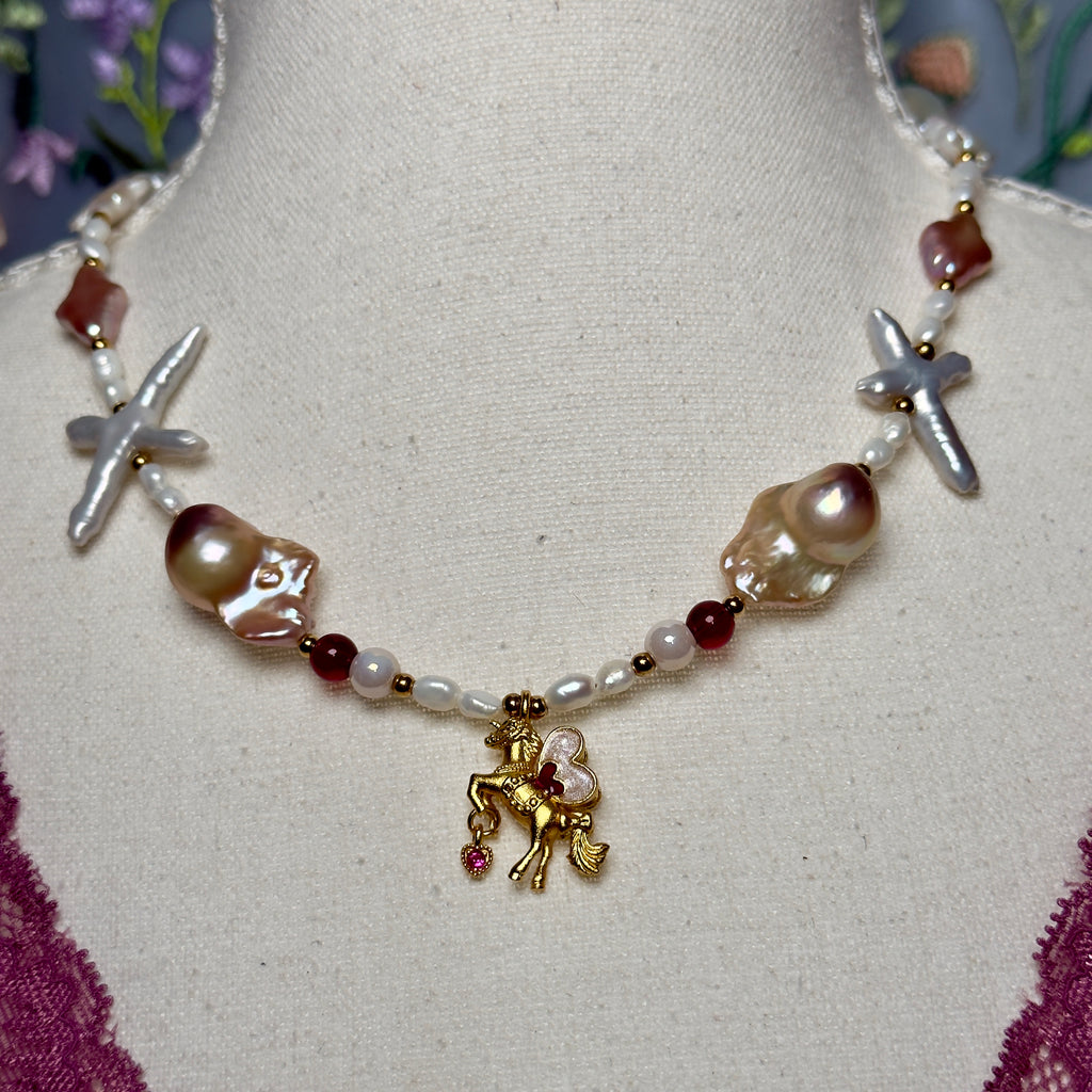Necklace with horse charm and various beads on a mannequin bust.
