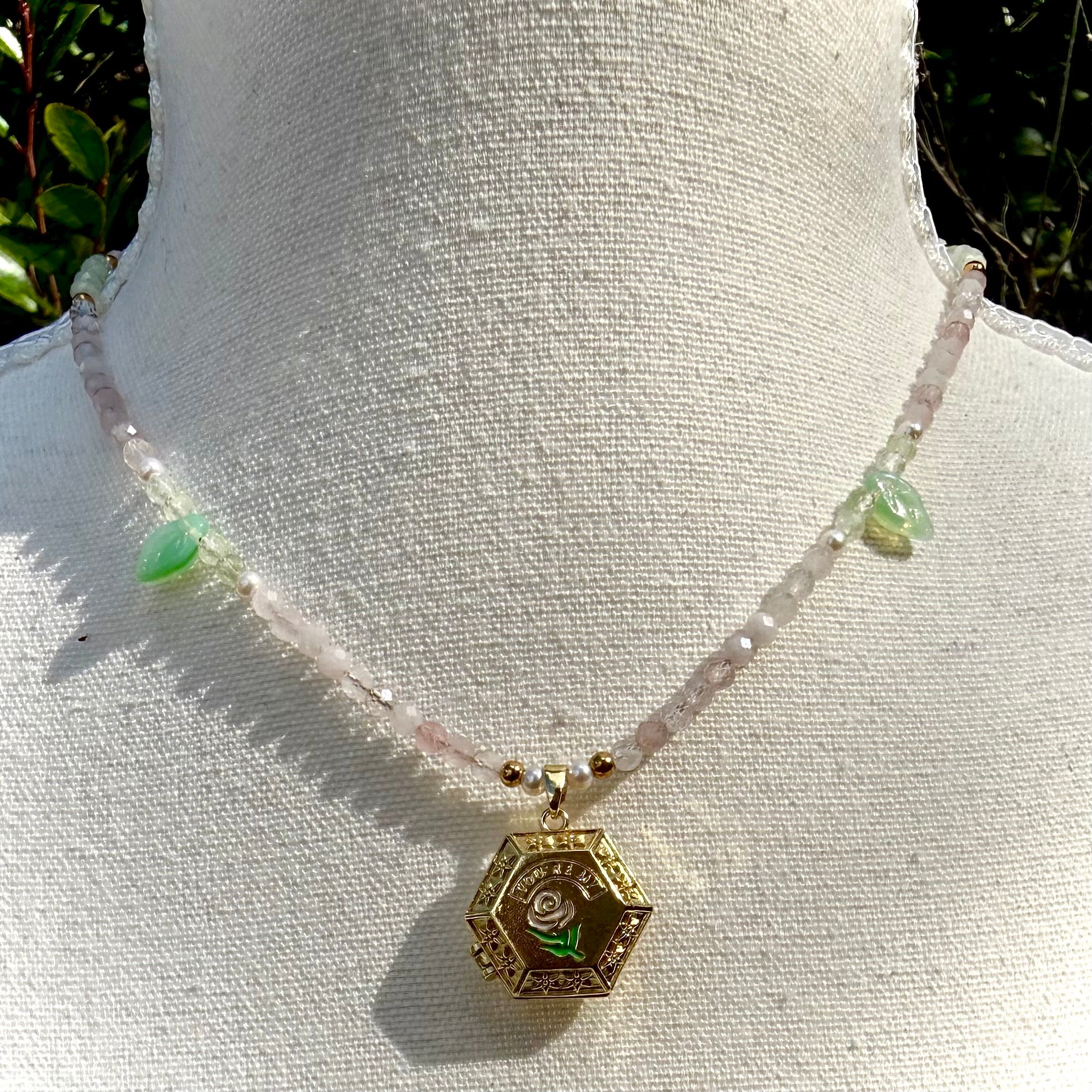 Necklace with a hexagonal locket pendant on a mannequin bust