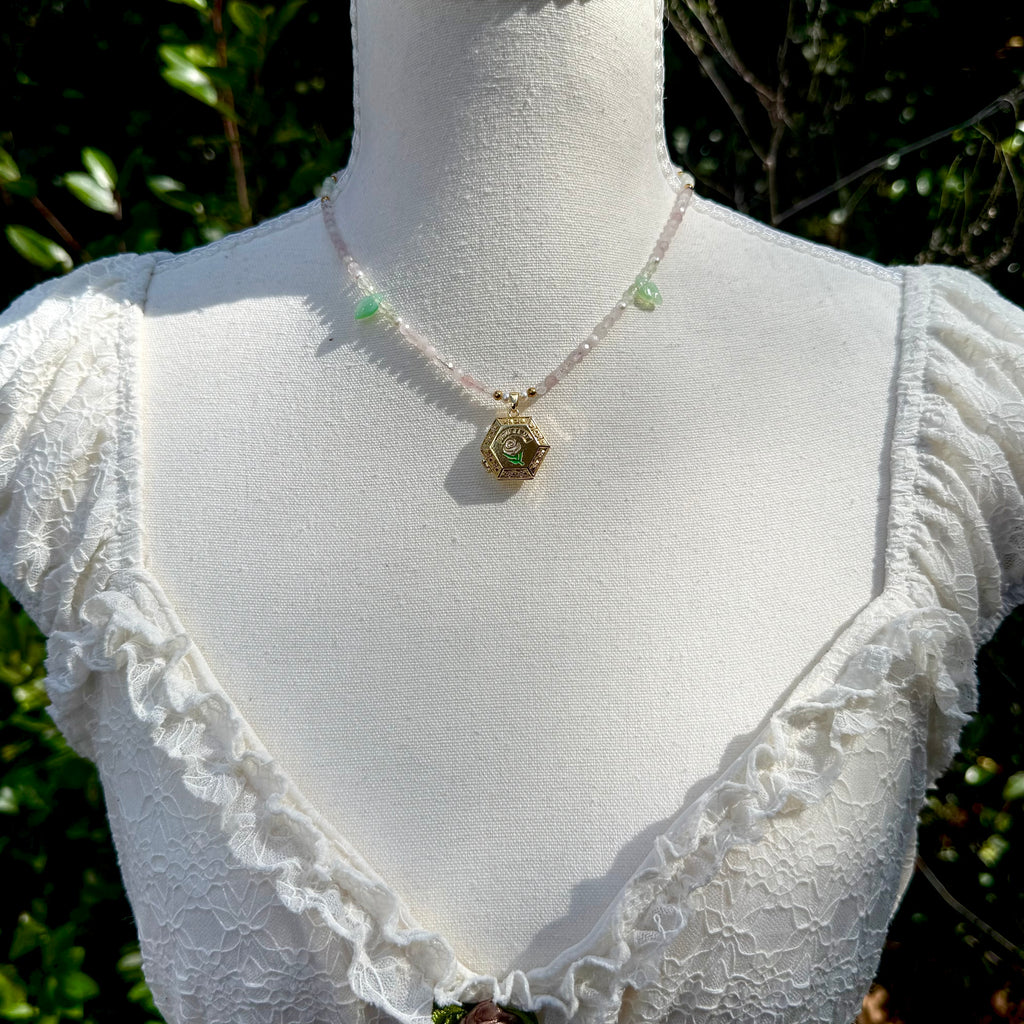 Mannequin wearing a white lace top with a necklace against a natural background