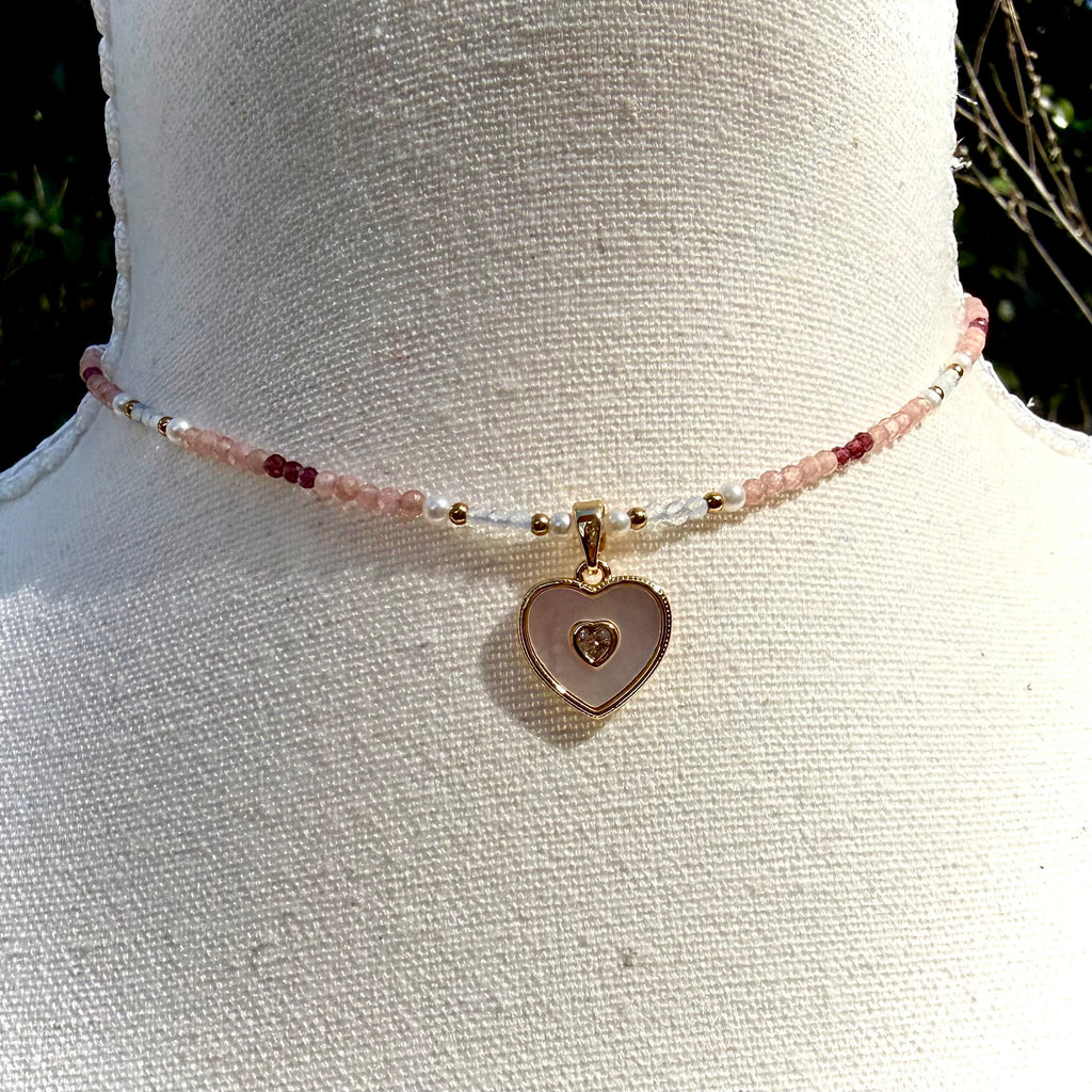 Necklace with a heart-shaped pendant on a mannequin bust.