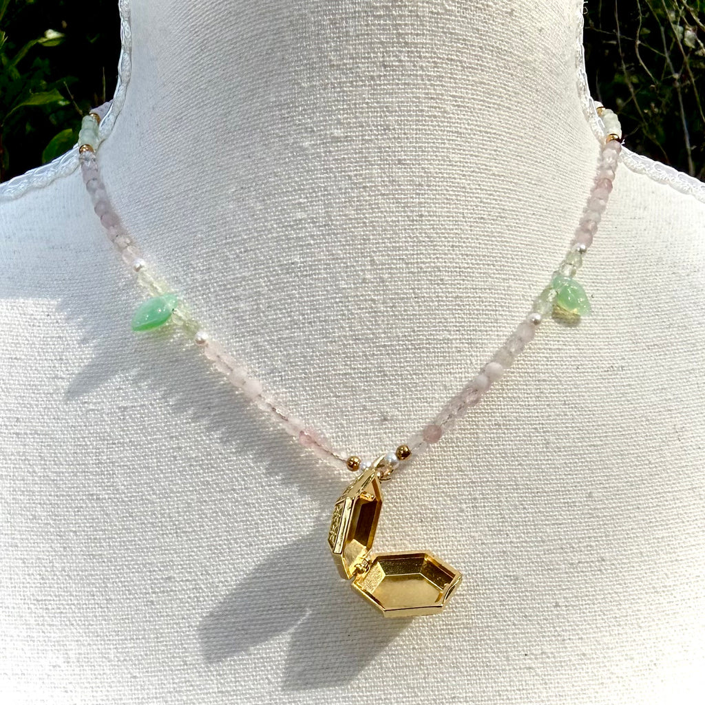 Necklace with a gold pendant on a mannequin against a white background