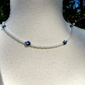 Necklace with blue beads on a mannequin against a natural background