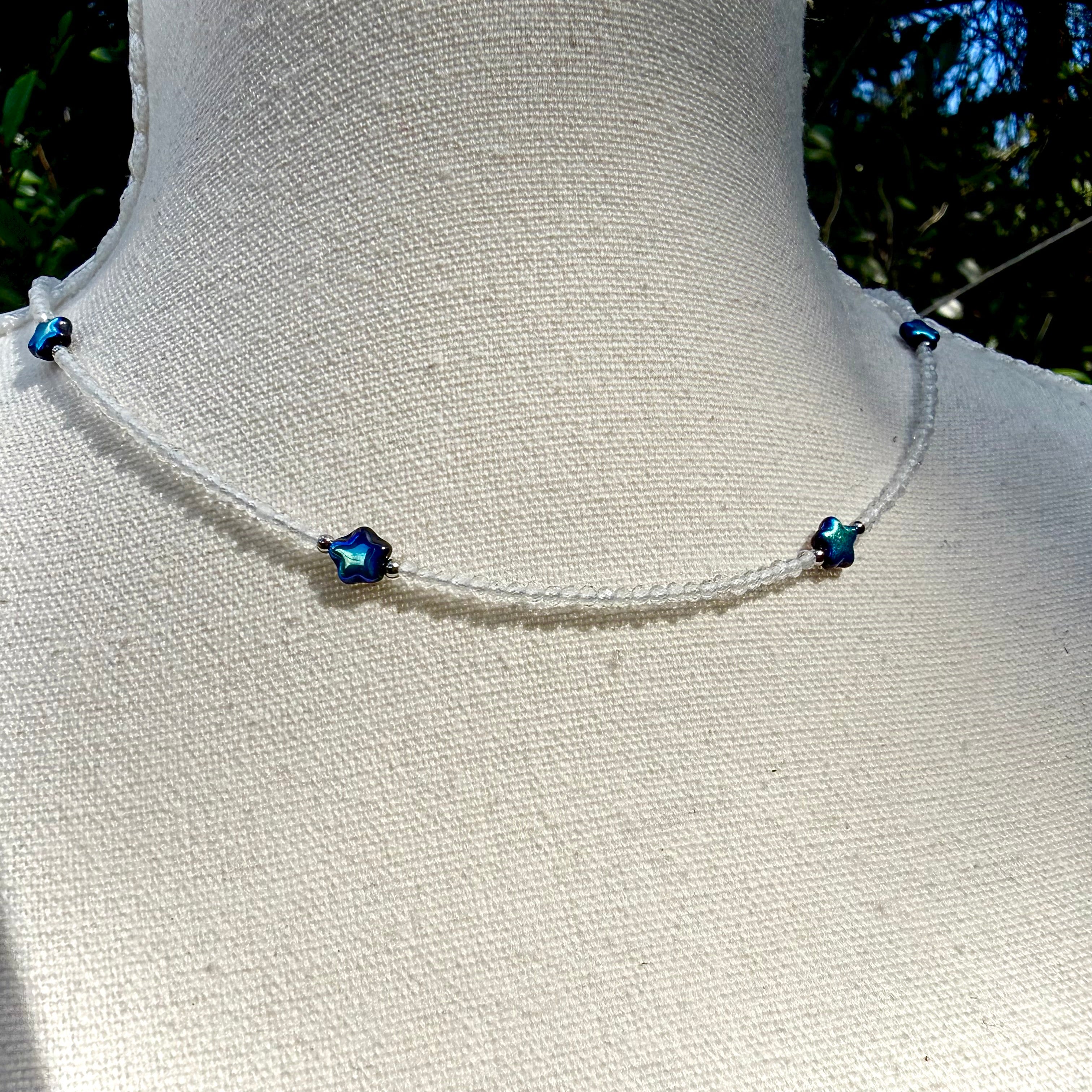 Necklace with blue beads on a mannequin against a natural background