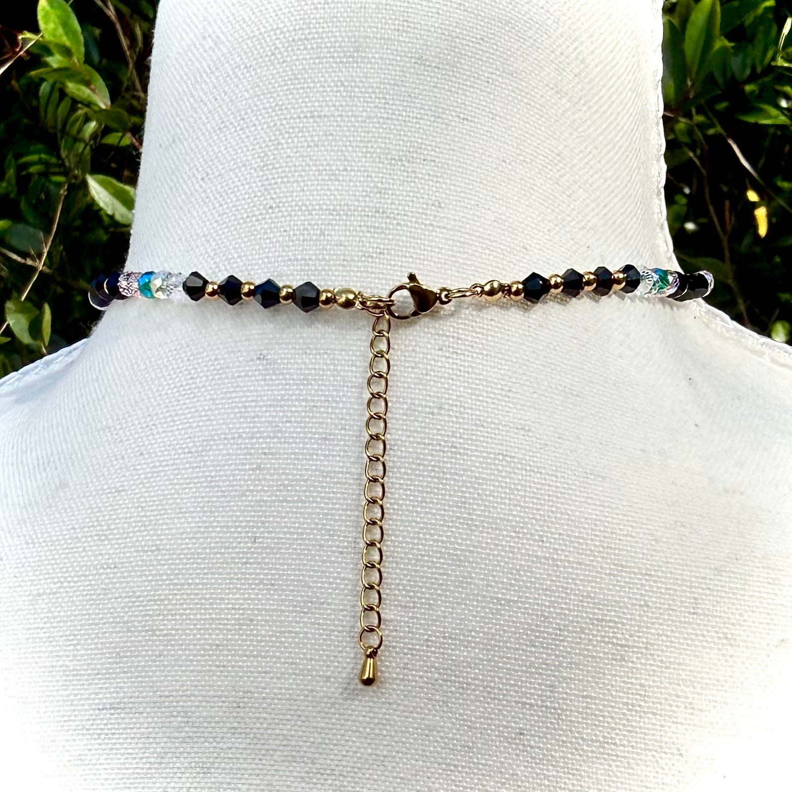 Back of Beaded necklace on a mannequin with a natural background