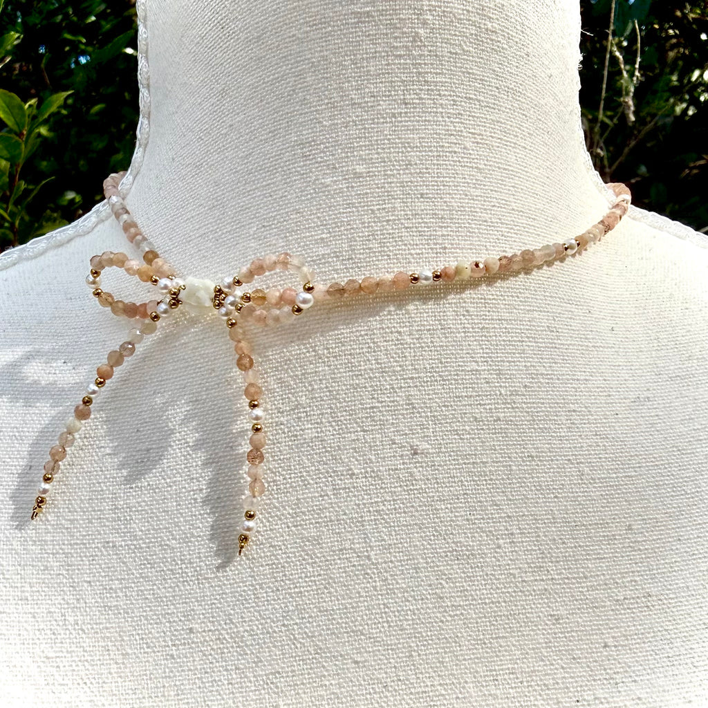 Necklace with beads on a mannequin against a natural background