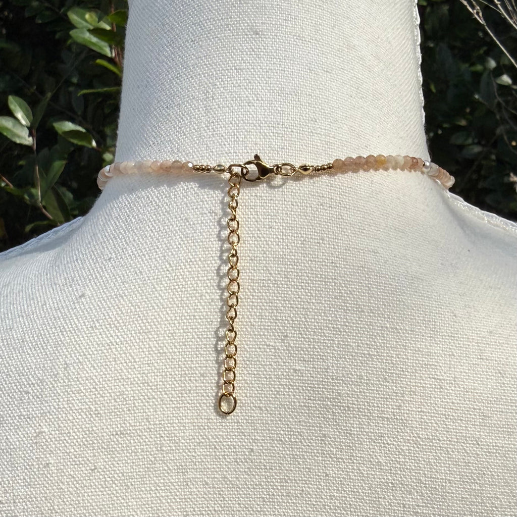 Back of necklace on a mannequin with a natural background
