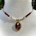 Necklace with pearl and red bead chain on a mannequin bust.